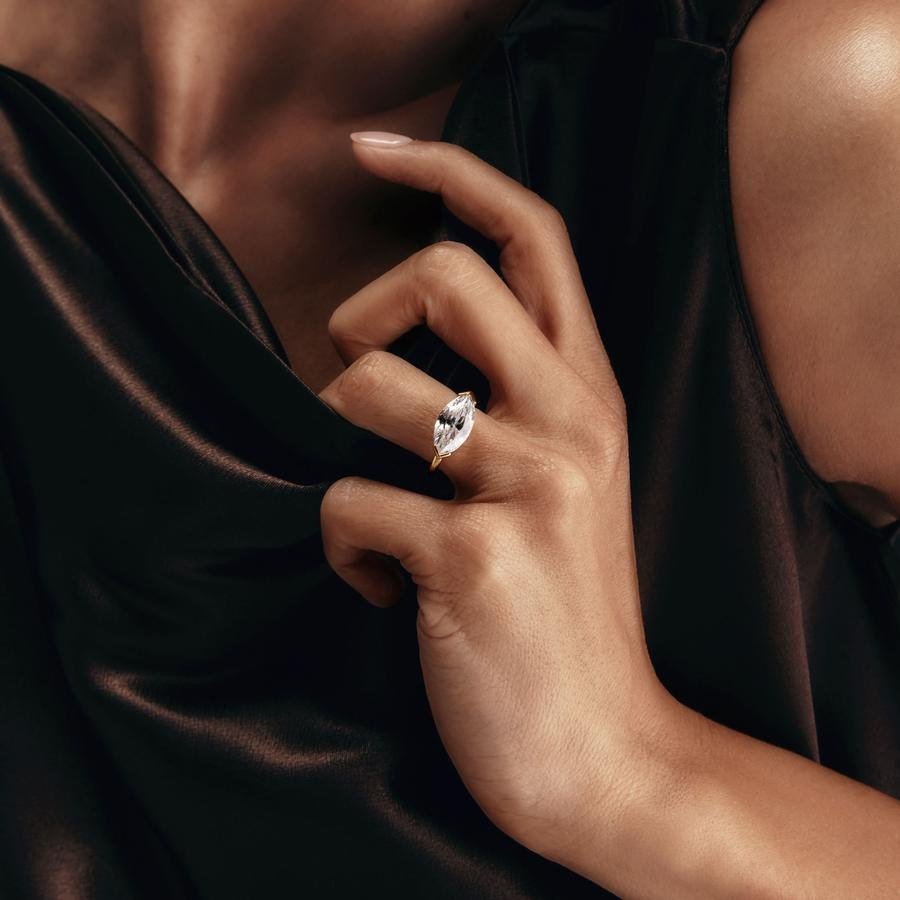 Pear-shaped diamond ring on black silk, worn